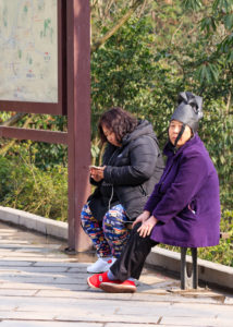 ZhangJiaJie bag lady at bus stop