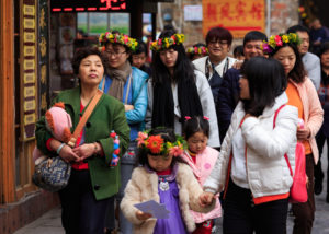 happy holiday makers with flowers in their hair FengHuang